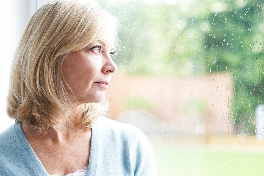 anxious woman looking at the window