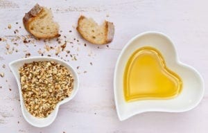 Dukkah with bread and olive oil in heart shaped bowls