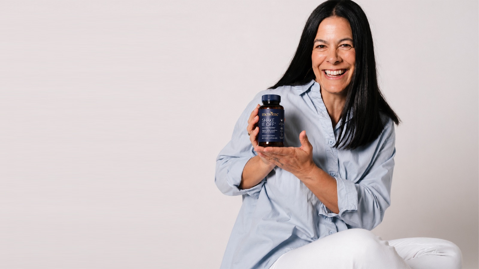 A woman holding Shake It Off, MenoMe's new capsules with Feiolix